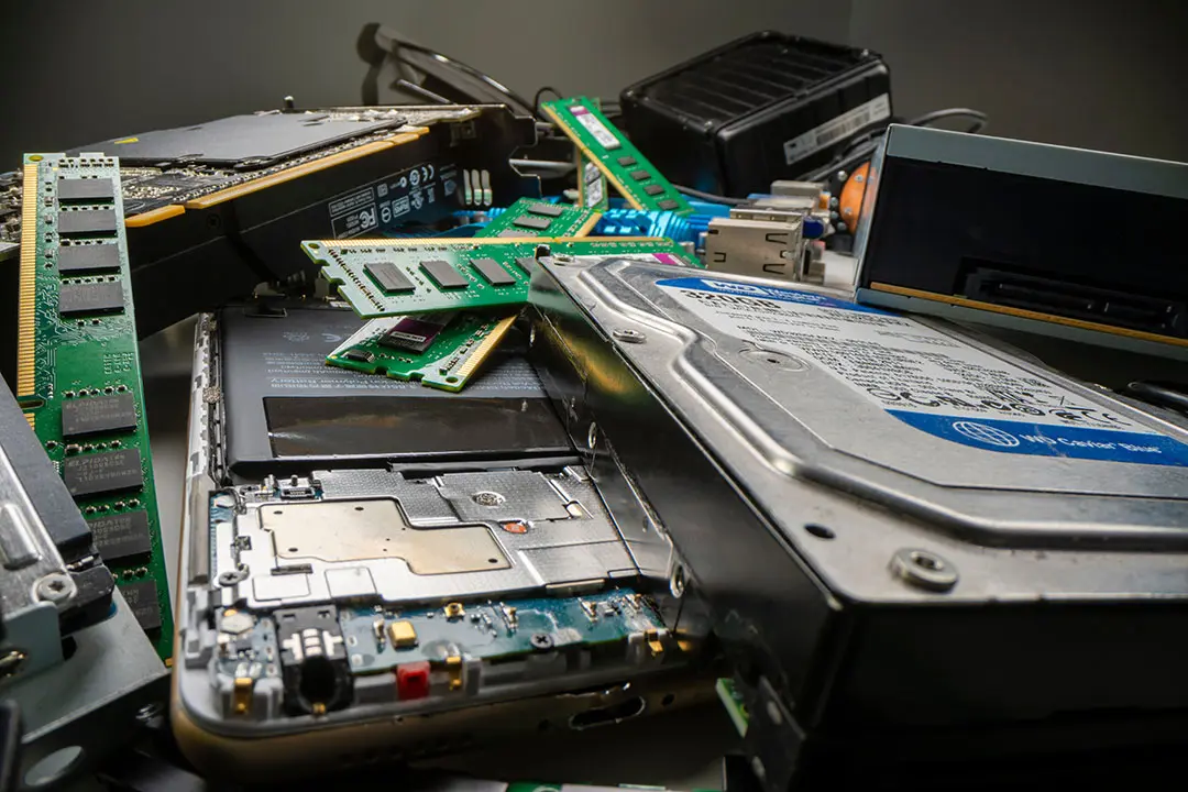 Old computer and network equipment is piled up and ready to be destroyed safely.